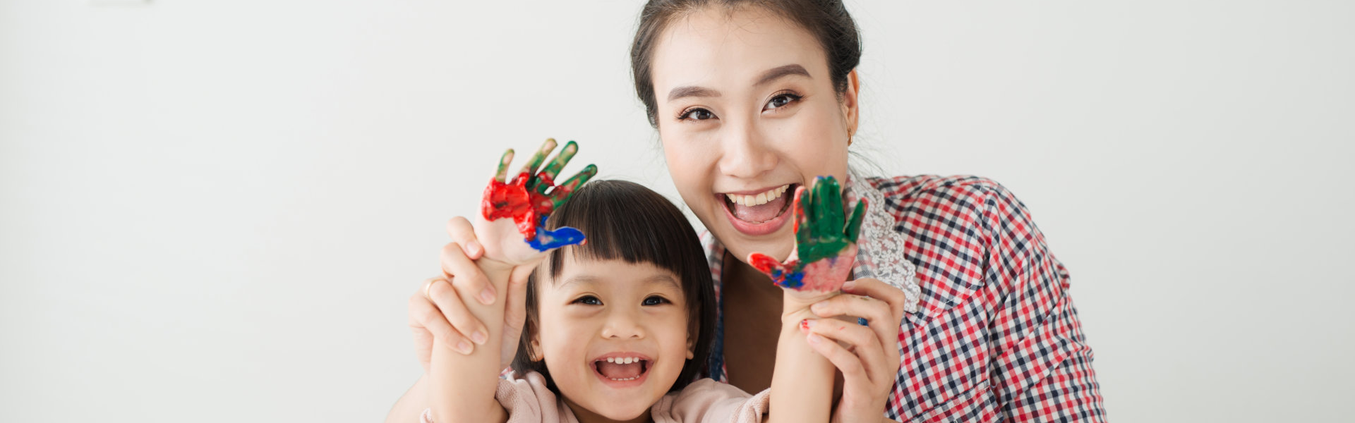 teacher and kid painting using their hands